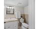 Bathroom featuring neutral tones, a toilet, a vanity, and a decorative mirror at 4860 S Salida Ct, Aurora, CO 80015
