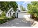Charming home with a well-manicured lawn, lovely landscaping, and an attached two-car garage at 4860 S Salida Ct, Aurora, CO 80015