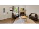 Cozy living room with a fireplace, two chairs, a table, and plenty of natural light at 4860 S Salida Ct, Aurora, CO 80015