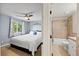 Bedroom featuring a ceiling fan, a large bed, and ensuite bathroom with shower-over-tub at 4860 S Salida Ct, Aurora, CO 80015