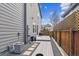 Backyard featuring gray siding, gravel landscape, wood fence, and deck at 8157 E 53Rd Dr, Denver, CO 80238