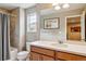 Bathroom with a bathtub and shower, a large mirror over the sink, and neutral walls at 8157 E 53Rd Dr, Denver, CO 80238