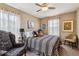 Cozy bedroom with decorative pillows, neutral colored walls, and multiple windows for natural light at 8157 E 53Rd Dr, Denver, CO 80238