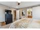 Bedroom with a view of the ensuite, a TV, and a comfy looking throw blanket at 8157 E 53Rd Dr, Denver, CO 80238