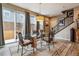 Stylish dining room with glass table, modern light fixture and patio access at 8157 E 53Rd Dr, Denver, CO 80238