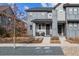 Two-story home with grey siding, covered porch, and tasteful landscaping at 8157 E 53Rd Dr, Denver, CO 80238