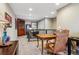 Carpeted hallway with a decorative armoire and mirror, and a leather office chair at 8157 E 53Rd Dr, Denver, CO 80238