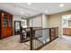 Second floor hallway with carpet, neutral walls, wooden railing, and a view down to the first floor at 8157 E 53Rd Dr, Denver, CO 80238