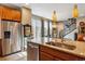 Sun-filled kitchen with granite countertops, stainless appliances and backyard access at 8157 E 53Rd Dr, Denver, CO 80238