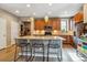 Well-lit kitchen featuring stainless steel appliances, granite countertops, a kitchen island, and wood cabinets at 8157 E 53Rd Dr, Denver, CO 80238