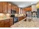 Updated kitchen featuring stainless steel appliances, granite countertops, tile backsplash and wooden cabinets at 8157 E 53Rd Dr, Denver, CO 80238