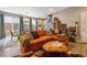 Comfortable living room with a large orange couch and decorative throw pillows, creating a cozy atmosphere at 8157 E 53Rd Dr, Denver, CO 80238