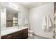 Modern bathroom featuring a dark wood vanity with a white countertop and a large mirror at 1898 S Bannock St # 103, Denver, CO 80223