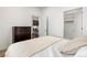 Neutral bedroom with a large closet, hardwood floors, and access to the kitchen at 1898 S Bannock St # 103, Denver, CO 80223