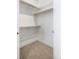 Walk-in closet with built-in shelving and carpet flooring at 1898 S Bannock St # 103, Denver, CO 80223