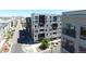 Contemporary building with large windows and balconies on a tree-lined street near the city skyline at 1898 S Bannock St # 103, Denver, CO 80223