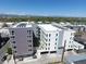 Modern building with rooftop HVAC units and parking garage in an urban setting with mountain views at 1898 S Bannock St # 103, Denver, CO 80223