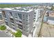 Modern apartment building with sleek gray facade, balconies, and a rooftop filled with HVAC units at 1898 S Bannock St # 103, Denver, CO 80223