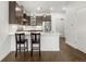 Kitchen island features a stainless steel sink, quartz counters, pendant lighting, and bar seating at 1898 S Bannock St # 103, Denver, CO 80223