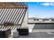 Rooftop patio lounge area with views of city skyline at 1898 S Bannock St # 103, Denver, CO 80223