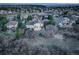 Aerial view of home nestled in a wooded lot, featuring backyard, and mountain views at 947 Buffalo Ridge Rd, Castle Pines, CO 80108