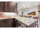 Granite countertop wet bar area with rich dark wood cabinetry and a built-in beverage center at 947 Buffalo Ridge Rd, Castle Pines, CO 80108