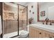 Elegant bathroom featuring a stone tiled shower, modern vanity, and stylish decorative accents at 947 Buffalo Ridge Rd, Castle Pines, CO 80108