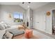 Cozy bedroom with a comfortable bed, a large window, and ample natural light at 947 Buffalo Ridge Rd, Castle Pines, CO 80108