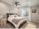 Comfortable bedroom with a large bed, ceiling fan, and a bright window with privacy features at 947 Buffalo Ridge Rd, Castle Pines, CO 80108