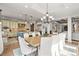 Open concept dining room with access to the kitchen and views of the backyard at 947 Buffalo Ridge Rd, Castle Pines, CO 80108