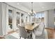 Bright and airy dining room with a chandelier and doors to the outside at 947 Buffalo Ridge Rd, Castle Pines, CO 80108