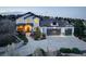 Stately home featuring a manicured lawn, three car garage, and a covered entryway at 947 Buffalo Ridge Rd, Castle Pines, CO 80108
