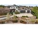 Beautiful two-story stucco home with a three-car garage and professionally landscaped front yard at 947 Buffalo Ridge Rd, Castle Pines, CO 80108