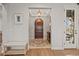 Elegant foyer with a hardwood front door, beautiful rug, and decorative light fixture at 947 Buffalo Ridge Rd, Castle Pines, CO 80108
