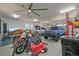 Large garage with multiple vehicles, ceiling fan, and speckled flooring at 947 Buffalo Ridge Rd, Castle Pines, CO 80108