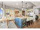 Open kitchen featuring a wine refrigerator, island seating, and stainless steel appliances at 947 Buffalo Ridge Rd, Castle Pines, CO 80108
