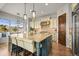 A spacious kitchen with a large center island, bar seating, and pendant lighting at 947 Buffalo Ridge Rd, Castle Pines, CO 80108