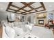 Cozy living room with a fireplace, decorative ceiling, and plenty of natural light at 947 Buffalo Ridge Rd, Castle Pines, CO 80108