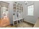 Mudroom with a built-in storage bench and shelving unit at 947 Buffalo Ridge Rd, Castle Pines, CO 80108