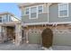 Exterior view of a two-story townhome with attached garage and landscaping at 9770 Mayfair St # C, Englewood, CO 80112