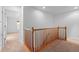 Upper hallway with wood railing and carpet at 9770 Mayfair St # C, Englewood, CO 80112