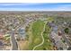 Aerial view showcasing a golf course community by a lake, promoting an active lifestyle at 13420 Lafayette St, Thornton, CO 80241