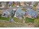 Aerial view of a house with a patio, fire pit, and well-manicured lawn at 13420 Lafayette St, Thornton, CO 80241