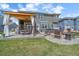 Large backyard featuring an outdoor kitchen, patio, fire pit, and hot tub ideal for entertaining and relaxation at 13420 Lafayette St, Thornton, CO 80241