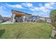 Wide backyard featuring a spacious lawn, pergola, hot tub and manicured landscaping at 13420 Lafayette St, Thornton, CO 80241