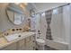 Charming bathroom with stylish vanity, mirror, patterned tile floor, and shower-tub combo at 13420 Lafayette St, Thornton, CO 80241