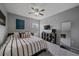 Cozy bedroom with a ceiling fan, stylish decorations, and a full-length mirror adding depth to the room at 13420 Lafayette St, Thornton, CO 80241