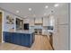 Kitchen featuring an island with granite countertops, stainless steel appliances, and shaker style cabinets at 13420 Lafayette St, Thornton, CO 80241