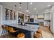 Island kitchen featuring granite countertops, barstool seating, and a wine rack display at 13420 Lafayette St, Thornton, CO 80241