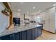 Kitchen featuring an island with granite countertops, stainless steel appliances, and shaker style cabinets at 13420 Lafayette St, Thornton, CO 80241